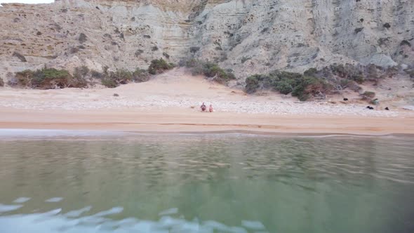 Woman and man on Gavdos beach, Greece. Vacation concept, aerial view