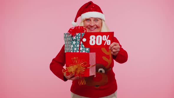 Grandmother in Christmas Sweater Showing Gift Box and 80 Percent Discount Inscriptions Banner Text