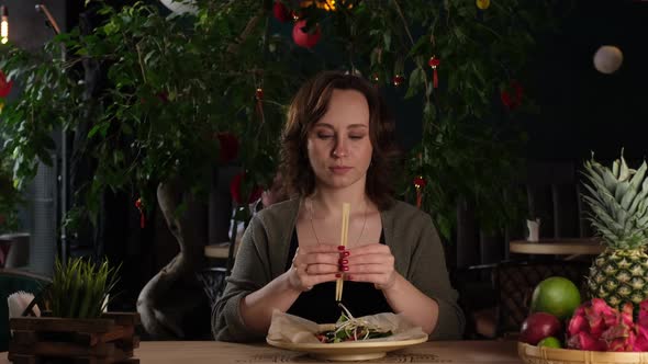 Girl Preparing to Eat with Chopsticks