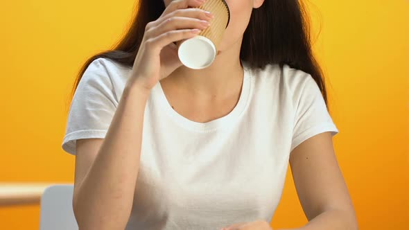 Young Female Enjoying Taste of Hot Beverage, Smiling Into Camera Energetic Drink