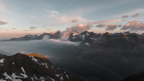 Hyperlapse of a mountain range in the Italian Alps at sunset with moving clouds