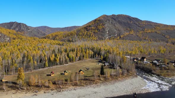 Village on the Banks of a Mountain River Near the Forest Autumn Sunny