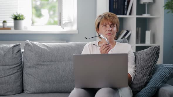 Pensive Woman with Laptop