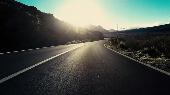 Long asphalt road ground view and travel concept - mountain and sky landscape - outdoor road trip