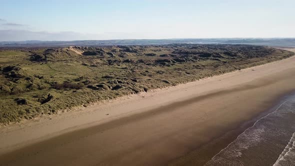 Aerial Drone View Of Green Field At The Saunton Sands Beach On The North Devon Coast In England - as