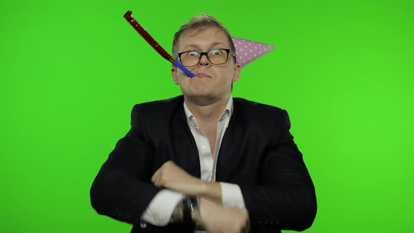 Drunk Disheveled Young Businessman in Festive Cap Celebrates and Dances