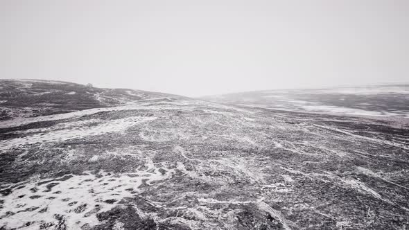 Foggy Mountain Landscape with Snow Cornice Over Abyss Inside Cloud