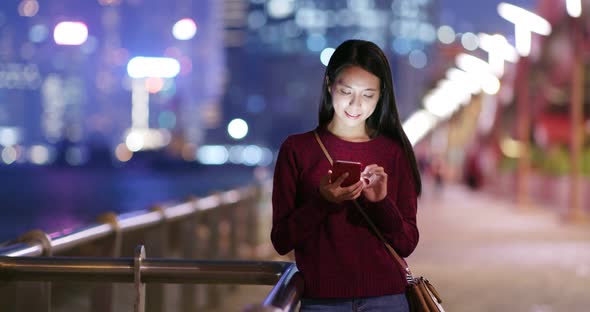 Woman use smart phone online at night