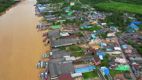 Aerial shot of river and local fisherman village beside the sea