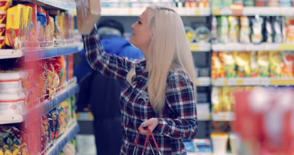 Woman Buys Food in a Shopping Center