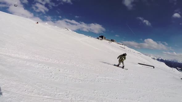 A young man snow boarding.