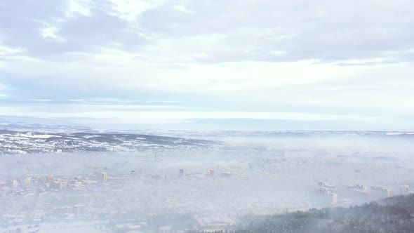 Smog from individual household heating above city 4K drone video