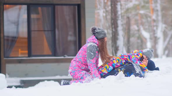 Joyful Family with Little Daughter Has Fun in Snowdrift