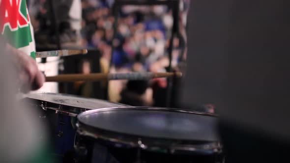 Hockey Fan Plays Drums Supporting Sportsmen at Match