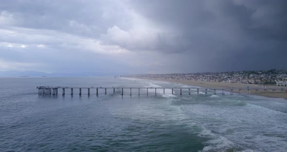 Aerial pullback of an ocean storm gathering by Manhattan Beach Pier, California