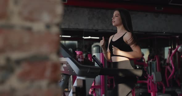 Beautiful Woman Running On Treadmill In Fitness Center