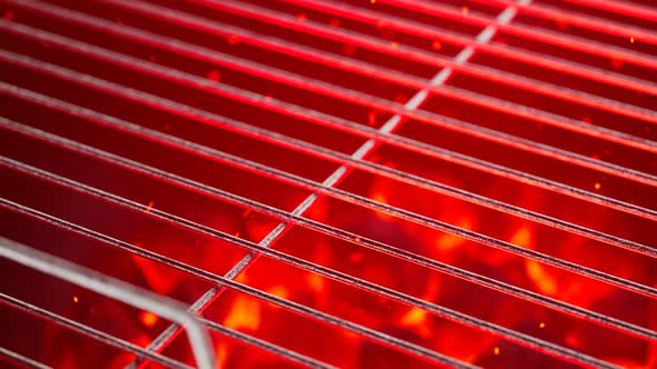 Empty grill with red very hot charcoal on dark background. Ready for grilling.