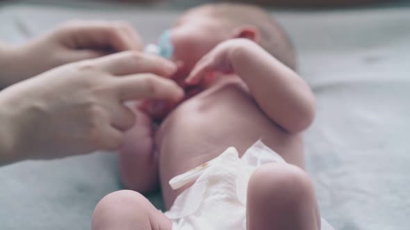 Lovely Mother Hands Calm Down and Help Small Infant