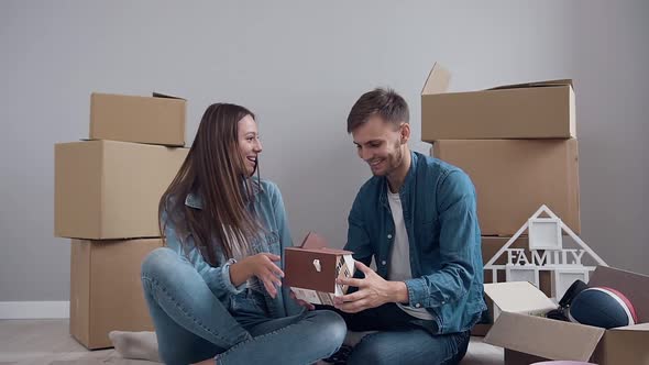 Happy Man and Woman in Love Giving Five to Each Other During Moving