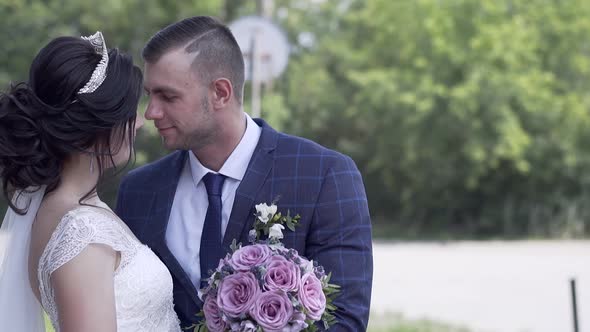 Slow Motion Fantastic Young Couple in Wedding Dressing Hugs