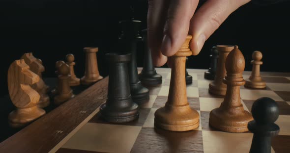 Close Up of Male Hand Moving White Queen Defeating Black King, Checkmate