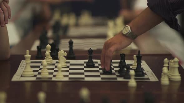 Close-up of Man Who Is Making Move in Chess Game. Hand of Chess Player Playing Chess.