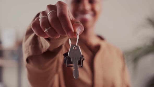 Young African American Woman Demonstrates Keys to House or Own Real Estate