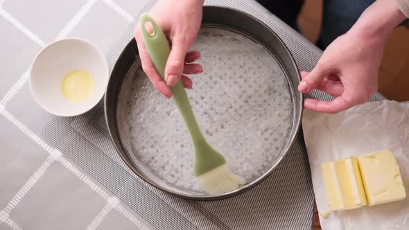 Closeup Video of Woman Buttering a Cake Pan for Baking Cake