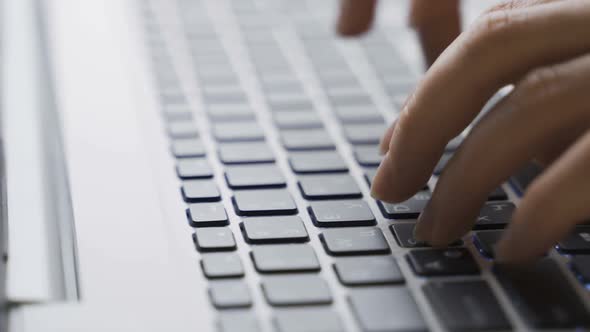 Woman Typing on Laptop Keyboard in the Office