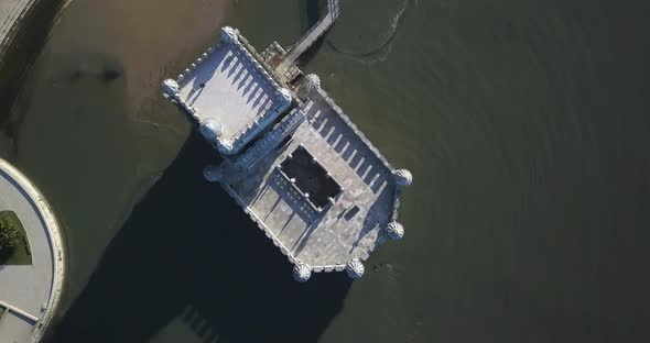 Aerial view of Belem Tower built on a small island in the Tagus River with Lisbon in the background.