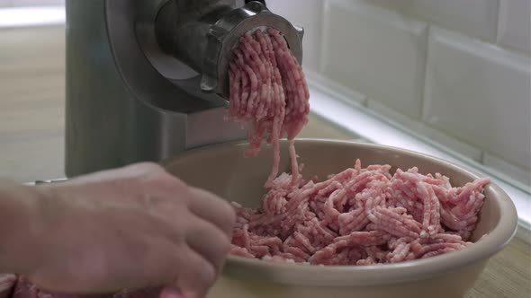 Making Minced Meat in Electric Grinder From Fresh Pork at Home in the Kitchen