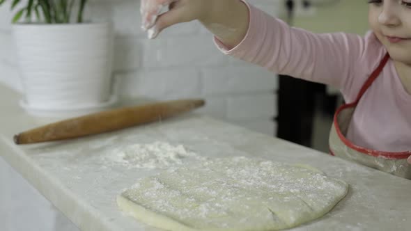 Cooking Pizza. Little Child in Apron Sprinkle the Dough with Flour in Kitchen