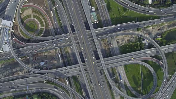 Aerial View of Highway Road Interchange with Busy Urban Traffic Speeding on Road