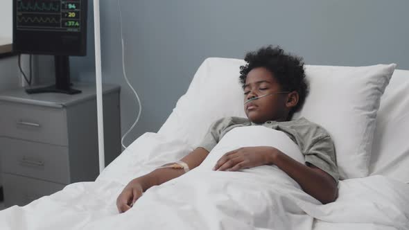 Unconscious Boy in Hospital Bed