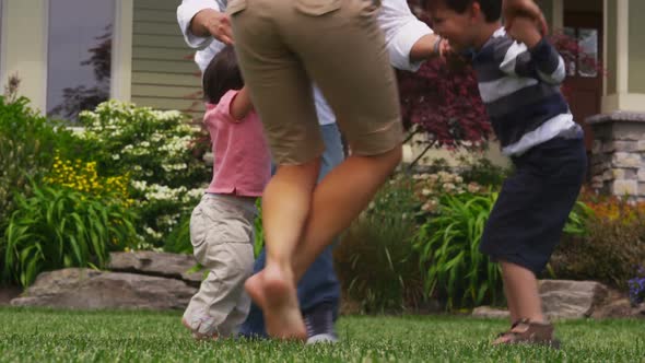 Portrait of family playing in grass together