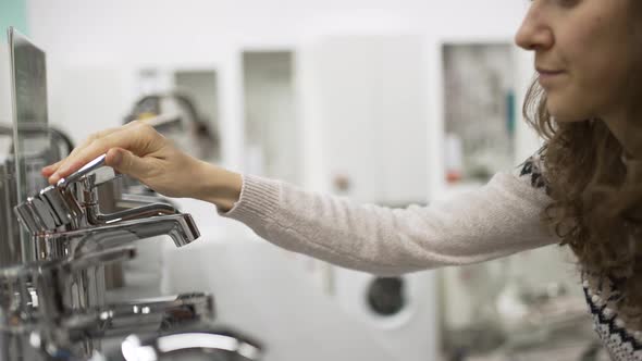 Young Woman Looks for New Faucet for Apartment Renovation