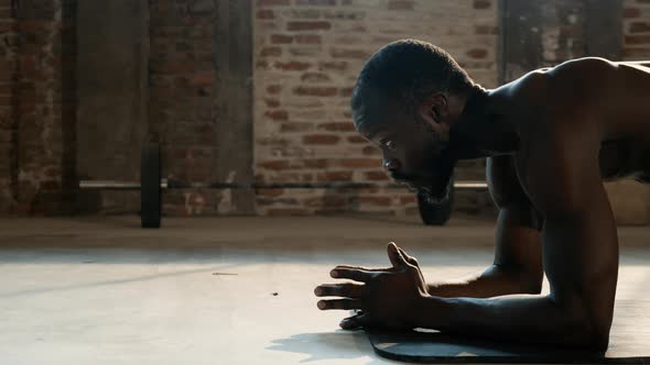 Sport man doing plank exercise, fitness workout at gym