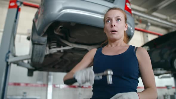 Woman Repairing Car Bottom alt