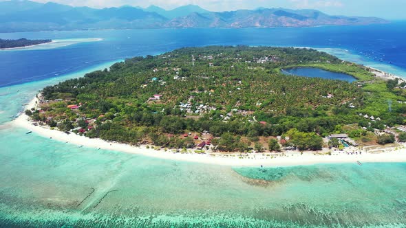 Beautiful above travel shot of a white sandy paradise beach and aqua turquoise water background in c