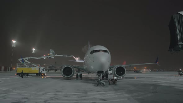 De-icing Tail Wings of the Airplane Before Night Departure