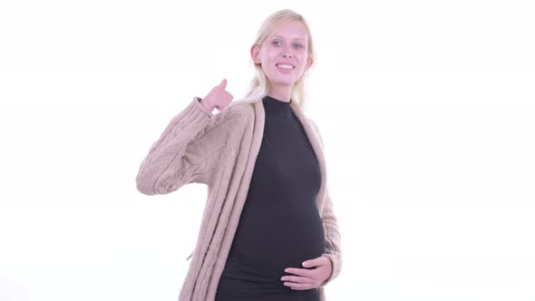 Happy Young Blonde Pregnant Woman Giving Thumbs Up
