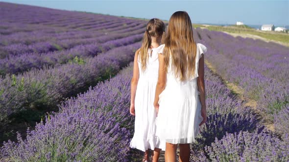 Girls in Lavender Flowers Field at Sunset in White Dress