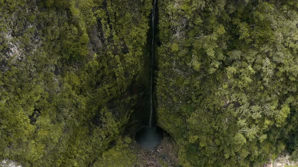 AERIAL: Misty waterfall in the mountains in Madeira