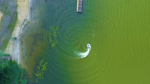 Luxury boat in dark color, fast movement on blue water, aerial view. Expensive luxury Italian boat m