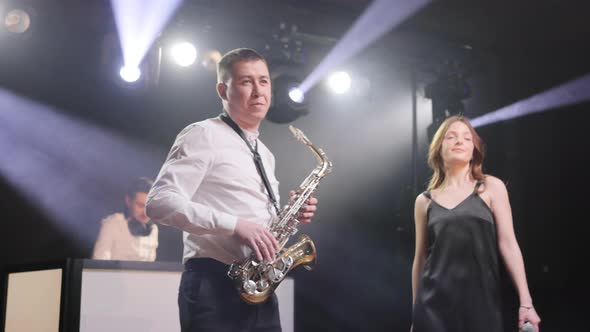 Musical Group Playing Song Performing on Concert Musician Stage with Lights