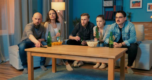 Five Good Friends Spend Evening in Each Other's Company Sitting on Couch in Living Room