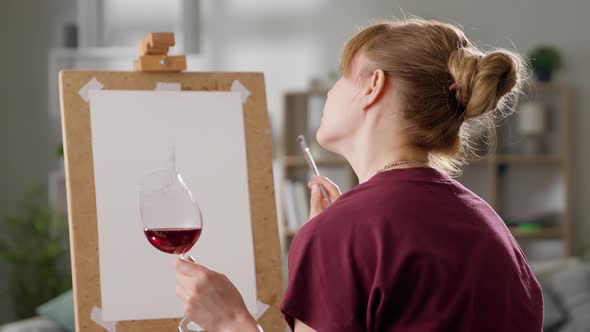 Portrait of a Young Woman with a Glass of Red Wine
