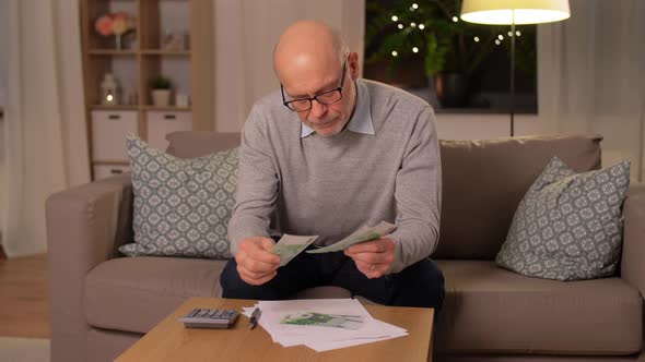 Senior Man Counting Money at Home