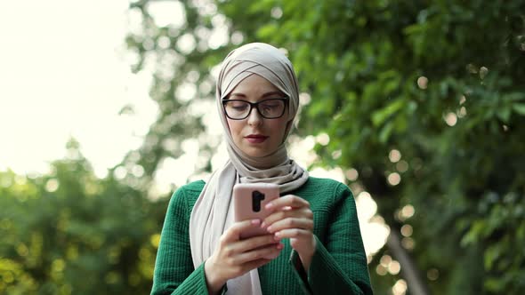 Portrait of Young Arabian Businesswoman Using Mobile Phone Outdoor