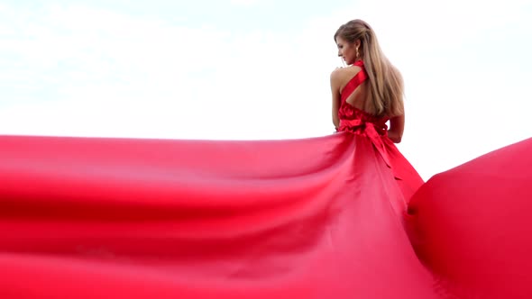 BAckside View of Young Gorgeous Woman in Long Red Dress